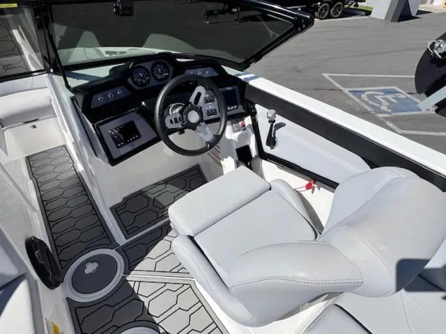 Slide: The Image of 2022 MasterCraft NXT20 boat interior with modern dashboard and comfortable seating. - 11