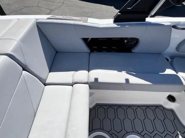 Slide: The Image of 2022 MasterCraft NXT20 boat interior with gray seating and hexagonal floor design. - 13