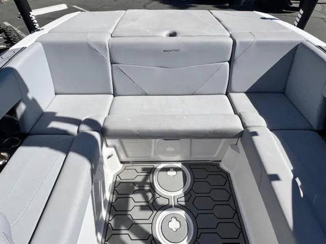 Slide: The Image of 2022 MasterCraft NXT20 boat interior with gray seating and patterned flooring. - 14