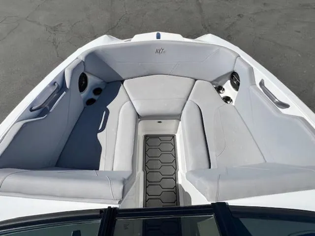 Slide: The Image of 2022 MasterCraft NXT20 boat interior with gray seating and cup holders. - 16