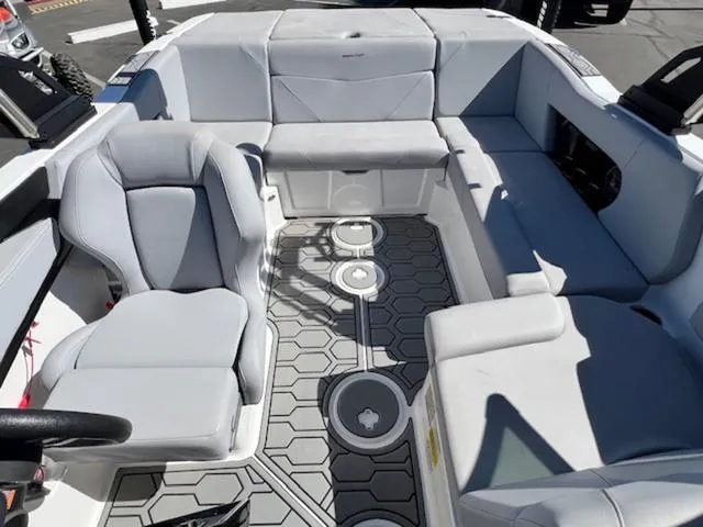 Slide: The Image of 2022 MasterCraft NXT20 boat interior with gray seating and hexagonal floor design. - 17