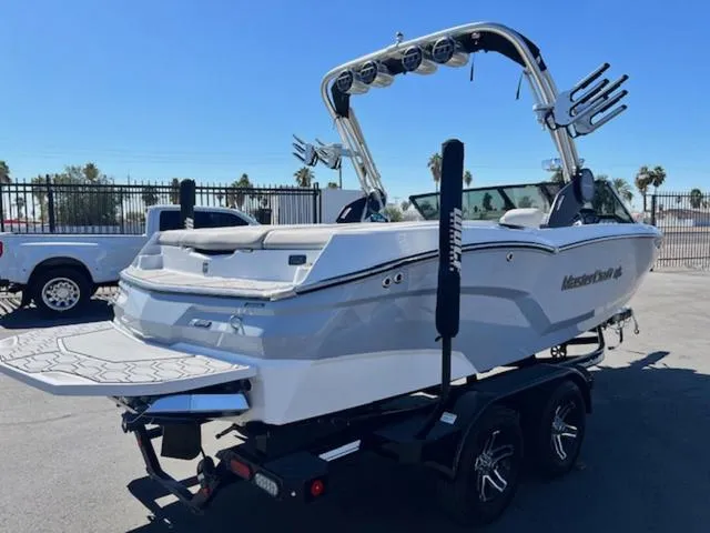 Slide: The Image of 2022 MasterCraft NXT20 boat on trailer, featuring sleek design and wakeboard tower. - 6