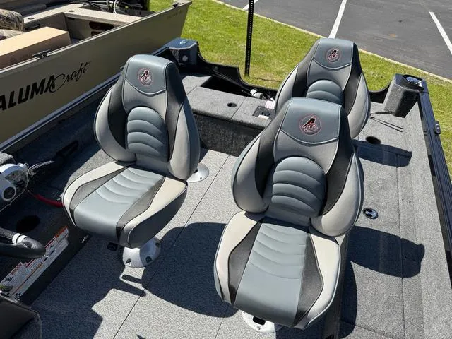 Slide: The Image of 2024 Alumacraft Classic 165 Side Console boat seats, featuring sleek gray and black design. - 11