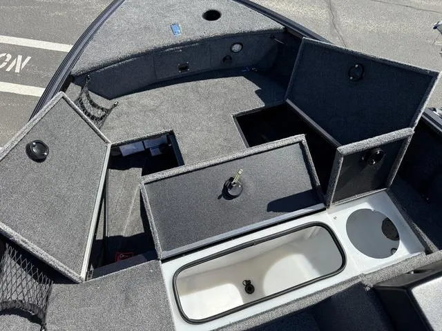 Slide: The Image of 2024 Alumacraft Classic 165 Side Console boat with open storage compartments. - 16