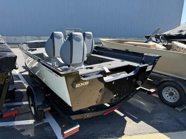 Slide: The Image of 2024 Alumacraft Classic 165 Side Console boat on trailer, parked outdoors. - 3