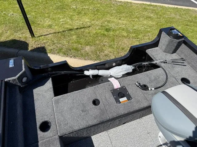 Slide: The Image of 2024 Alumacraft Classic 165 Side Console boat interior with gray seating and storage compartments. - 5
