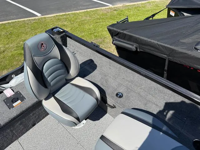 Slide: The Image of 2024 Alumacraft Classic 165 Side Console boat interior with gray seating and carpeted deck. - 7