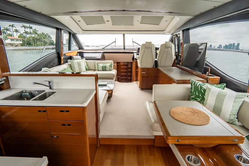 Slide: The Image of Luxurious 2017 Princess S65 yacht interior with elegant seating, wood finishes, and scenic ocean views. - 10