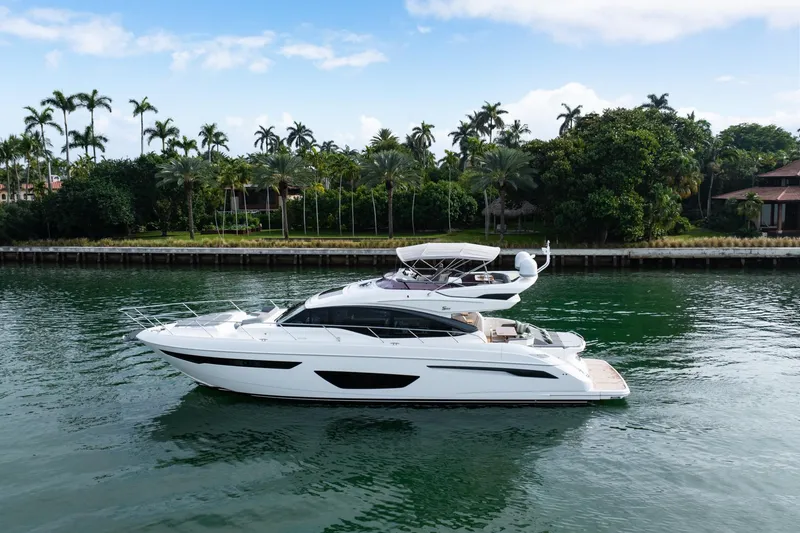 Slide: The Image of Luxurious 2017 Princess S65 yacht cruising on a serene waterway, surrounded by lush greenery. - 4