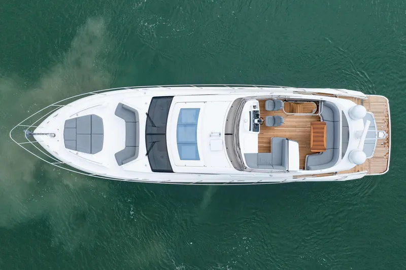 Slide: The Image of Aerial view of 2017 Princess S65 yacht on water, showcasing sleek design and spacious deck. - 9