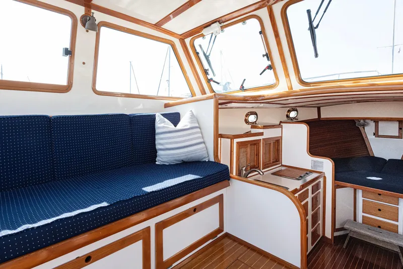 Slide: The Image of Interior of 1985 Wilbur 34 boat with blue seating and wooden accents. - 10
