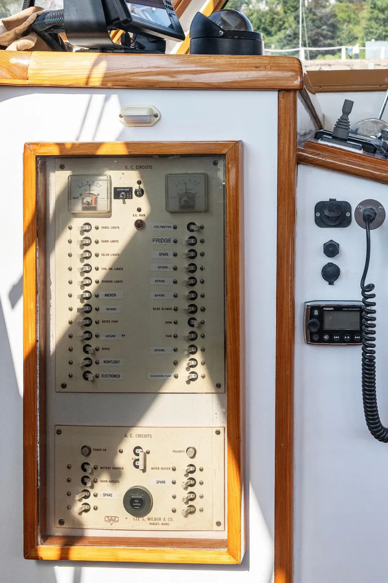 Slide: The Image of 1985 Wilbur 34 boat control panel with switches and gauges. - 15