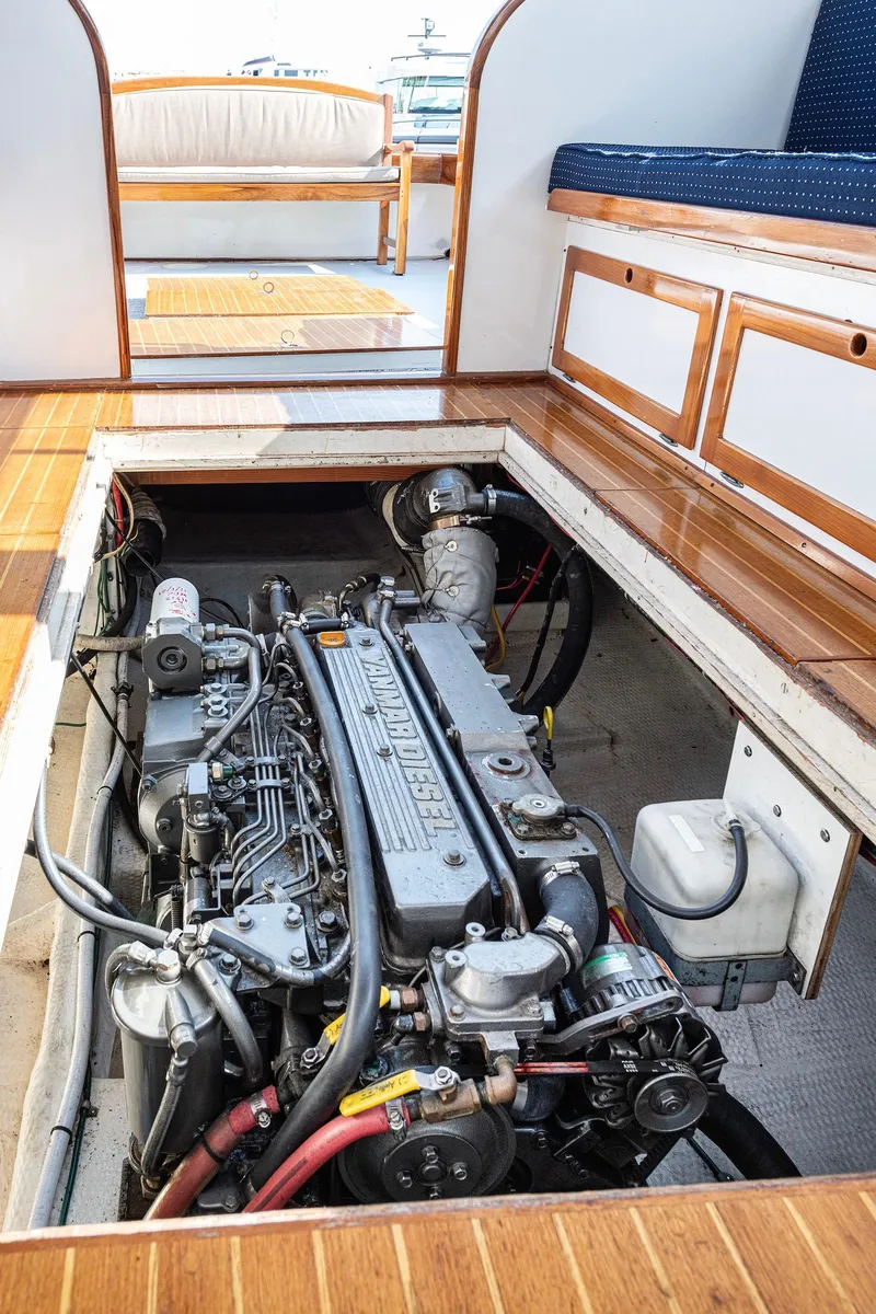 Slide: The Image of Engine compartment of a 1985 Wilbur 34 boat, showcasing detailed mechanical components. - 16