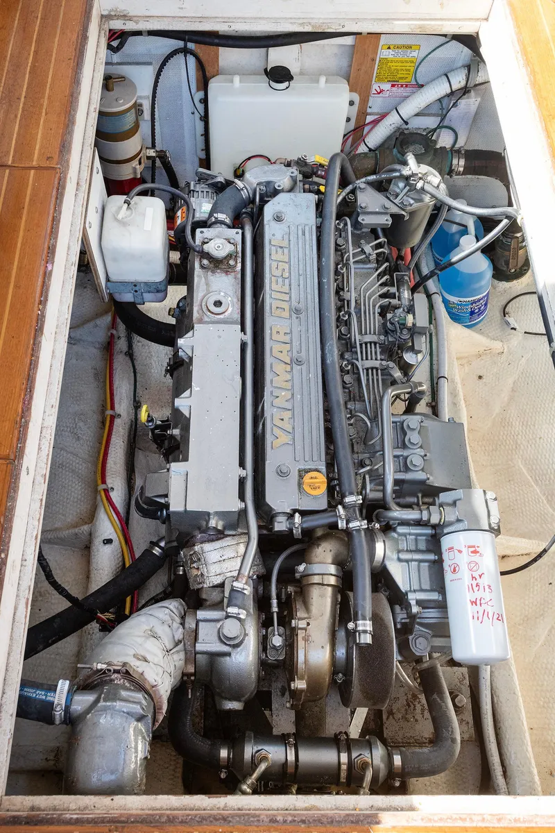 Slide: The Image of Engine compartment of a 1985 Wilbur 34 boat, showcasing detailed mechanical components. - 17