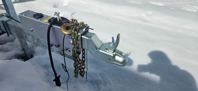 Slide: The Image of Trailer hitch in snow, Wilbur 34 model, 1985, with chains and shadow. - 30