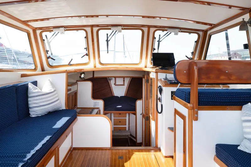 Slide: The Image of Interior of 1985 Wilbur 34 boat with blue seating and wooden accents. - 6