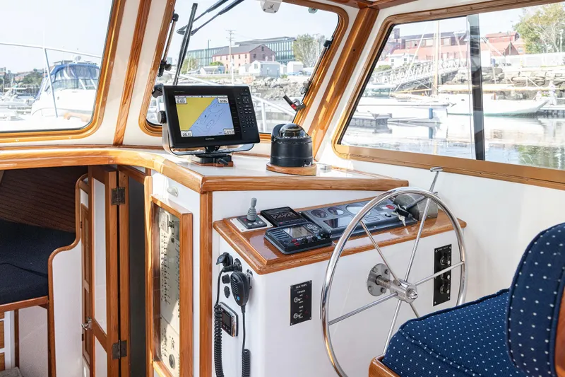 Slide: The Image of 1985 Wilbur 34 boat interior with navigation equipment and steering wheel. - 8