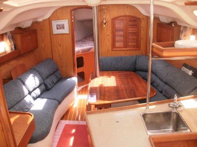 Slide: The Image of Interior of 2000 Hunter 380 sailboat with cozy seating and wooden finishes. - 15