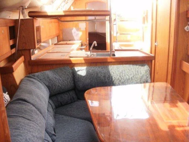 Slide: The Image of Interior of 2000 Hunter 380 sailboat with cozy seating and wooden finishes. - 17