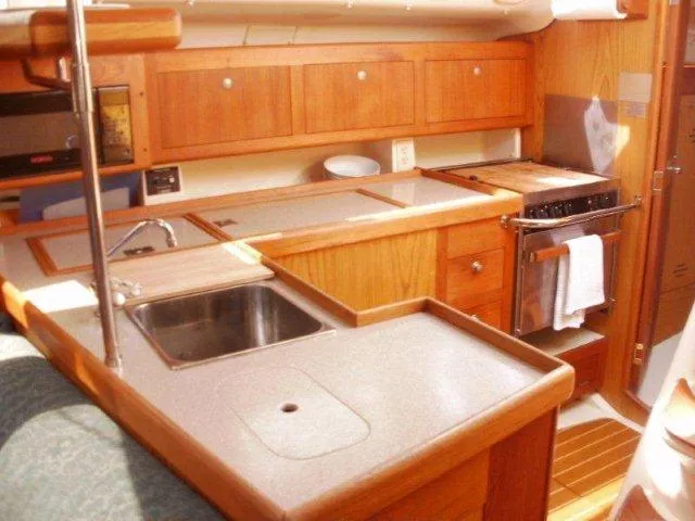 Slide: The Image of Interior of 2000 Hunter 380 yacht kitchen with wooden cabinetry and stainless steel sink. - 19