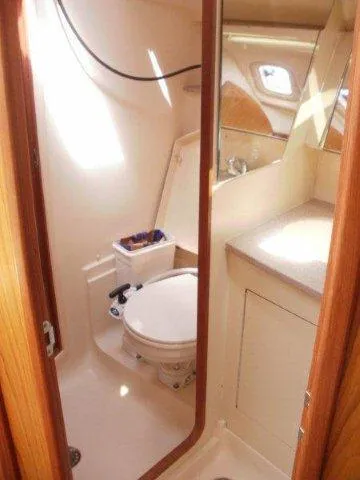 Slide: The Image of Compact bathroom in a 2000 Hunter 380 sailboat with toilet and sink. - 20