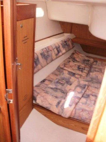 Slide: The Image of Cozy cabin interior of 2000 Hunter 380 sailboat with patterned bedding. - 21