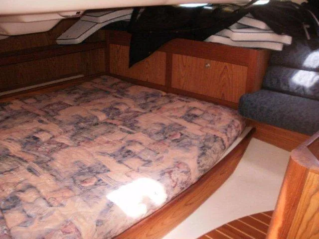 Slide: The Image of Cozy cabin interior of a 2000 Hunter 380 sailboat with a patterned bedspread. - 22