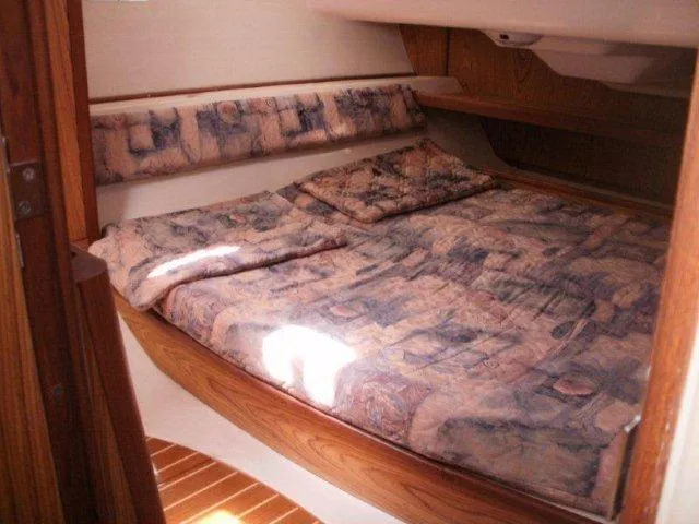 Slide: The Image of Cozy cabin interior of 2000 Hunter 380 sailboat with patterned bedding. - 23