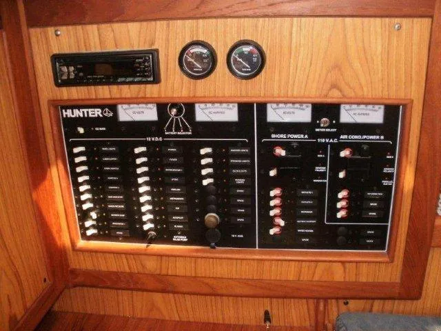 Slide: The Image of Electrical control panel on a 2000 Hunter 380 sailboat, featuring switches and gauges. - 25