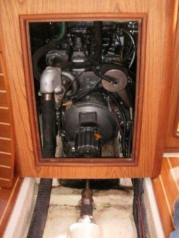 Slide: The Image of Engine compartment of a 2000 Hunter 380 sailboat, showcasing mechanical components. - 26