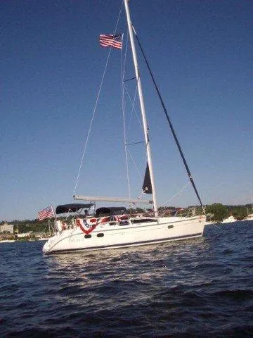 Slide: The Image of Sailboat on water, Hunter 380, 2000 model, with American flag and festive decorations. - 3
