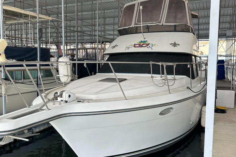 The Image of 1991 Carver 33 Aft Cabin yacht docked in a covered marina. - 0