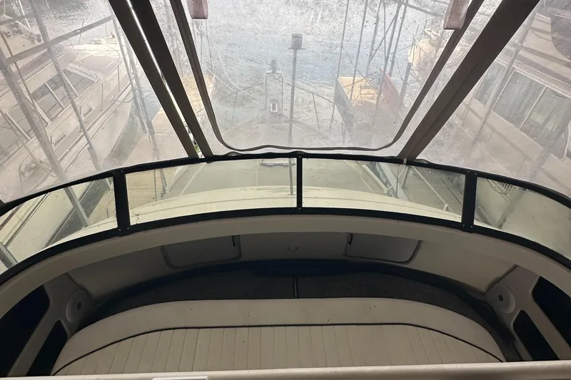 Slide: The Image of 1991 Carver 33 Aft Cabin interior view with marina background. - 10