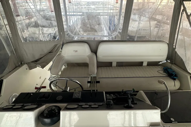 Slide: The Image of 1991 Carver 33 Aft Cabin helm with seating and navigation controls. - 11