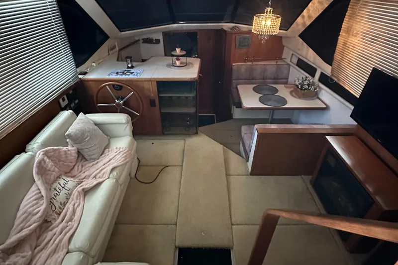 Slide: The Image of Interior of 1991 Carver 33 Aft Cabin yacht with cozy seating and dining area. - 13