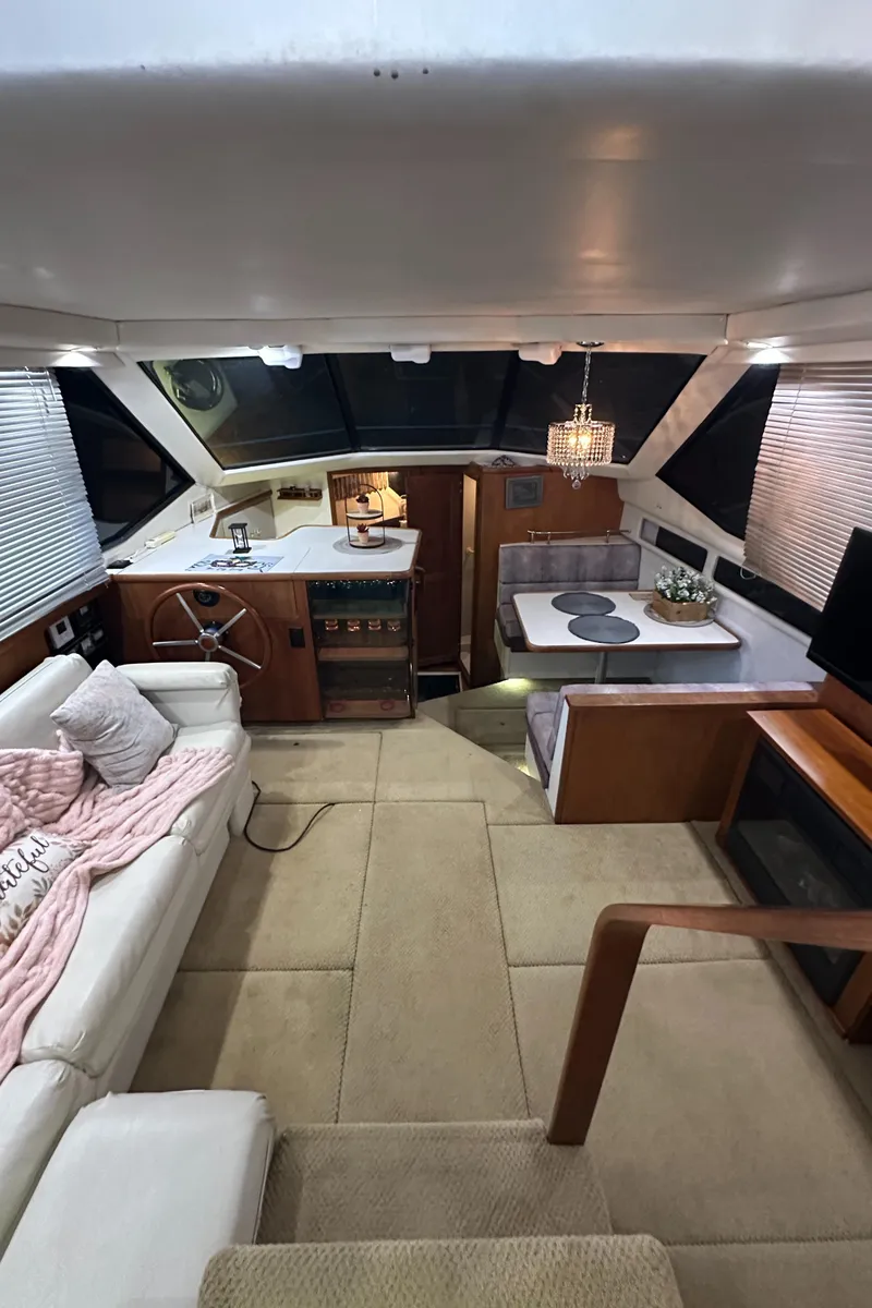Slide: The Image of Interior of 1991 Carver 33 Aft Cabin yacht with cozy seating and dining area. - 14