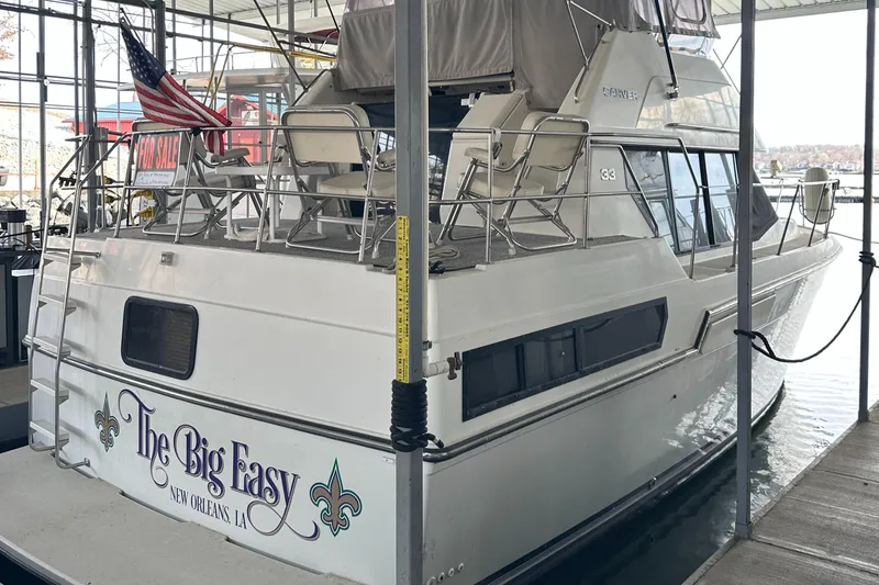 Slide: The Image of 1991 Carver 33 Aft Cabin boat named "The Big Easy" docked in a marina. - 2