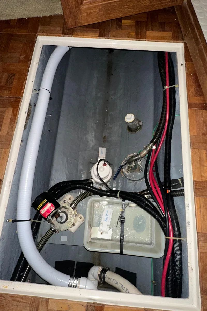 Slide: The Image of 1991 Carver 33 Aft Cabin engine compartment with wiring and plumbing. - 25