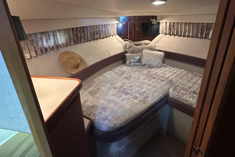 Slide: The Image of 1991 Carver 33 Aft Cabin interior with cozy bed and decorative pillows. - 31