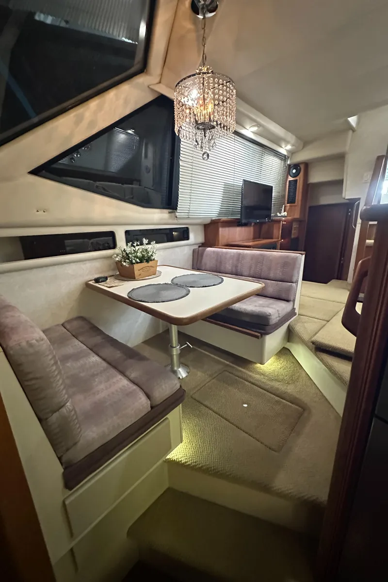 Slide: The Image of Interior of 1991 Carver 33 Aft Cabin with cozy dining area and modern decor. - 33
