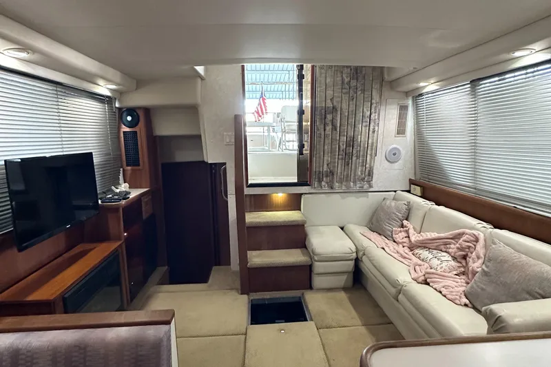 Slide: The Image of Interior of 1991 Carver 33 Aft Cabin with cozy seating and modern amenities. - 34
