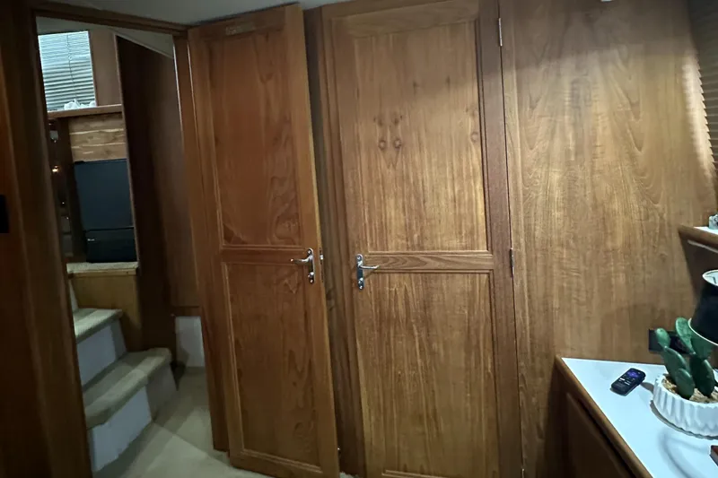 Slide: The Image of Interior of 1991 Carver 33 Aft Cabin with wooden doors and staircase. - 38