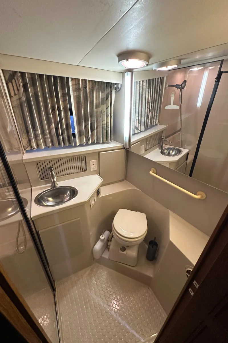 Slide: The Image of 1991 Carver 33 Aft Cabin bathroom with sink, toilet, and shower. - 39