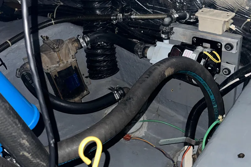 Slide: The Image of Engine compartment of 1991 Carver 33 Aft Cabin with hoses and mechanical components. - 44