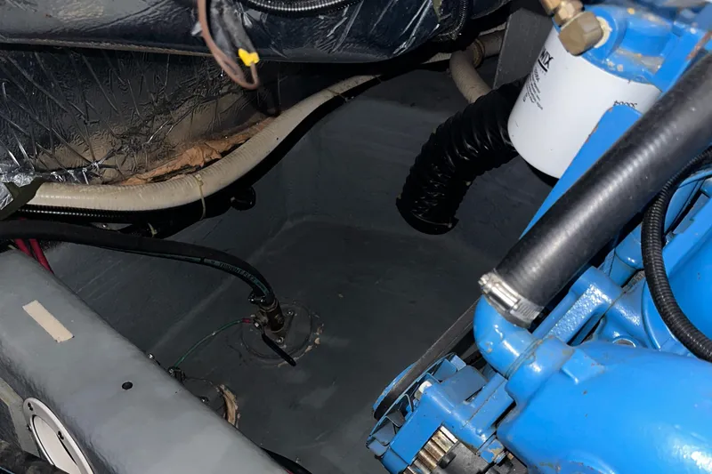 Slide: The Image of Engine compartment of 1991 Carver 33 Aft Cabin boat, showing mechanical components and hoses. - 45