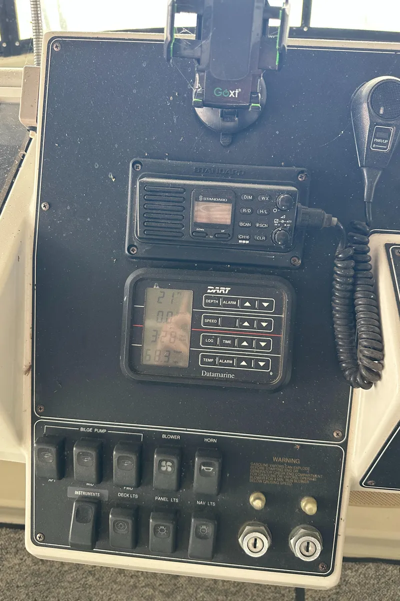 Slide: The Image of Control panel of a 1991 Carver 33 Aft Cabin boat with radio and switches. - 9