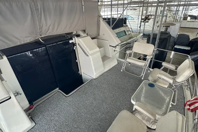 Slide: The Image of 1991 Carver 33 Aft Cabin boat interior with seating and carpeted deck. - 12