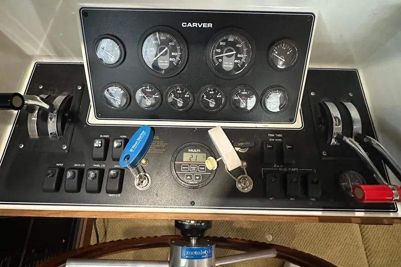 Slide: The Image of Control panel of a 1991 Carver 33 Aft Cabin boat with gauges and switches. - 22