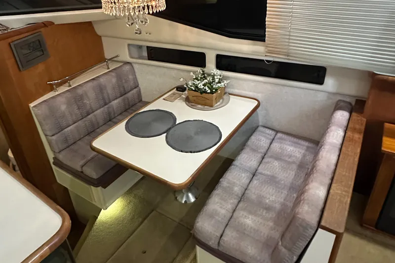 Slide: The Image of Interior of 1991 Carver 33 Aft Cabin with cozy dining area and plush seating. - 23