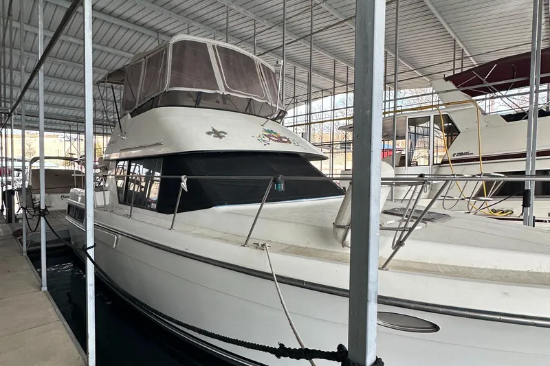 Slide: The Image of 1991 Carver 33 Aft Cabin yacht docked in a covered marina. - 3